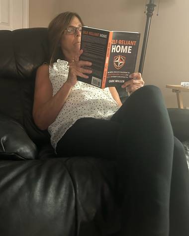 Debbie reading Self-Reliant Home